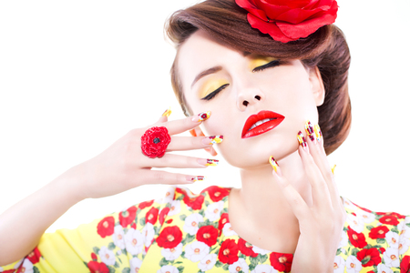 Close up of a woman. beauty make up concept with poppy theme: red lips, yellow eye shadows and poppy nail designの写真素材