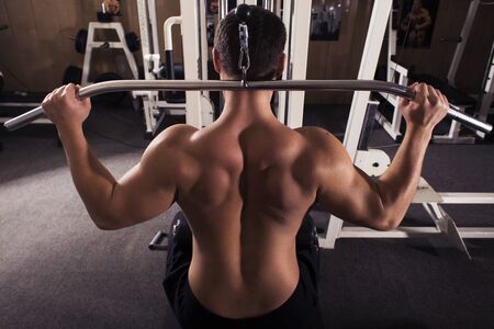 fit man trains in gym. alone. one. indoors