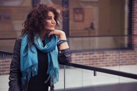 Brunette beautiful stylish caucasian woman in casual outfit on a walk on european city street. copy spaceの写真素材