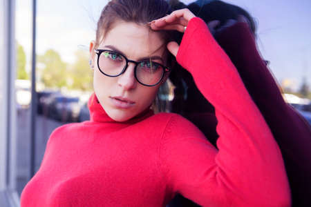 Beautiful caucasian woman in casual outfit outdoors walking, spending time in city. Sunny warm day. Stylish girlの写真素材