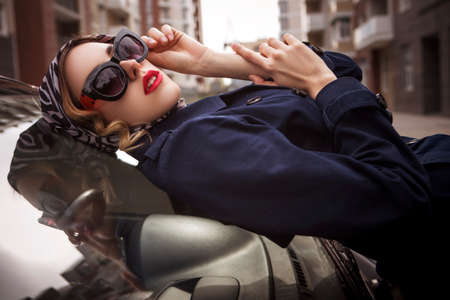 Beautiful brunette spy agent (killer or police) woman in jacket and sunglasses