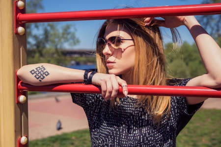 Beautiful caucasian woman in casual outfit outdoors walking, spending time in city. Sunny warm day....