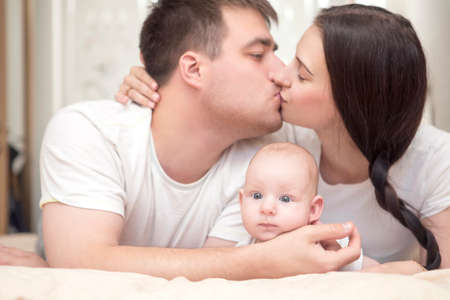 Happy loving caucasian family in casual outfit at home spend time together, smiling and hugging each...