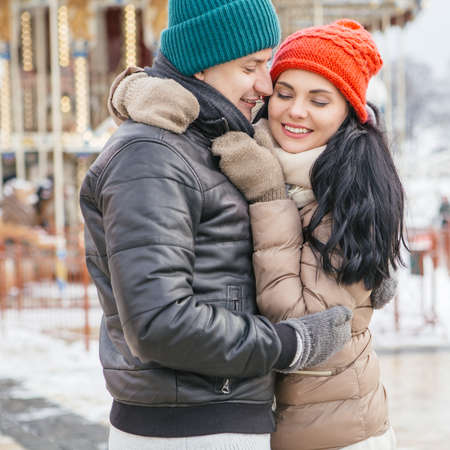 Cute happy loving couple of caucasian man and woman on a walk in snowy day with their weimaraner dog. Casual outfit, lifestyle imagesの写真素材