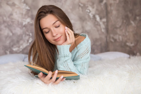 Young beautiful caucasian brunette woman sitting in casual clothes on a neutral background. Copy spaceの写真素材