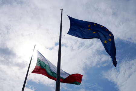 EU and Bulgaria flags waving in the wind against sky close-upの写真素材
