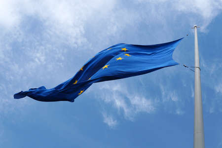 EU flag waving in the wind against the sky close-upの写真素材