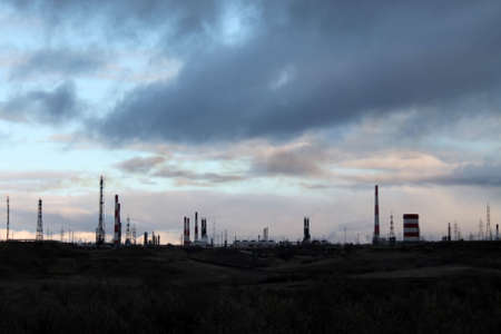 factory pipes produce dirty smoke into the sky