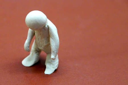 a figure of a drooping man, symbolizing a crisis, fatigue, collapse.の写真素材