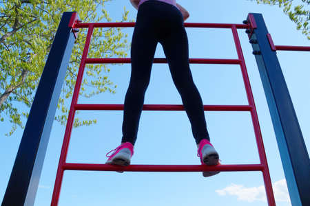 girl stands on a sports ladder, bottom viewの写真素材