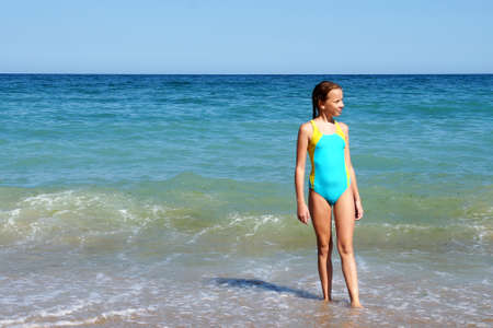 a girl in a swimsuit against the background of the sea horizon, copy spaceの写真素材