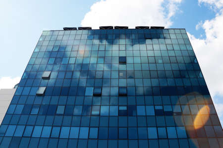 Clouds reflected in the glass facade of a skyscraper.