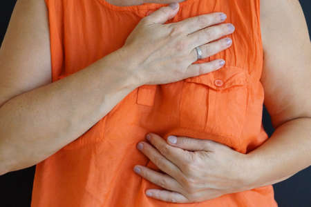 woman holding a sick heart