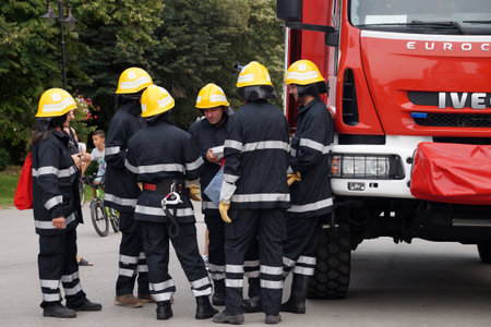 Varna, Bulgaria - September, 13, 2020: firefighters talking near a fire truck