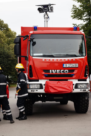 Varna, Bulgaria - September, 13, 2020: firefighters talking near a fire truck with retractable video...