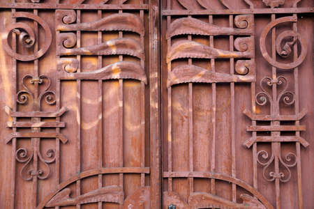 old metal brown gate decorated with forged elements close-upの写真素材