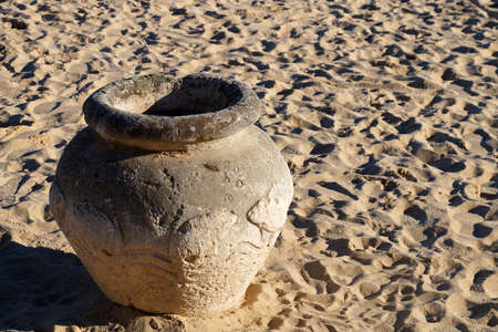 ancient clay pot on the sand close up