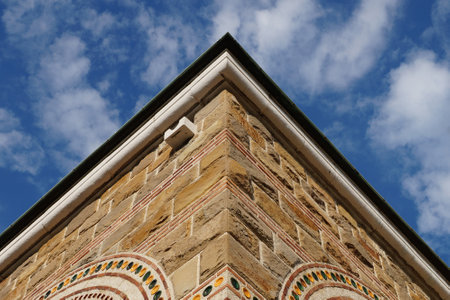 corner of an old building on a background of cloudy sky.の写真素材