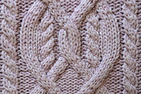 voluminous hand knitting close-up for a pink background