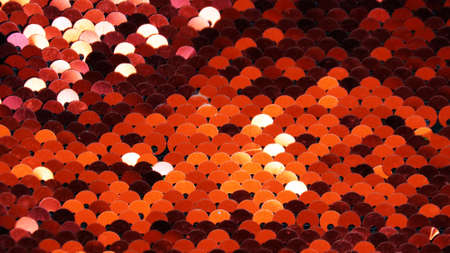 red blurred shiny background of sparkling sequins close upの写真素材