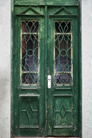 old exterior vintage wood green door with glass close-upの写真素材