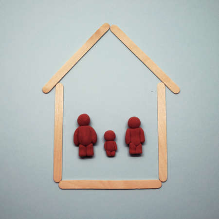 figurines of a man, woman and child in the house, family in their dwelling, copy spaceの写真素材