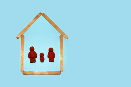 figurines of a man, woman and child in the house, family in their dwelling, copy spaceの写真素材