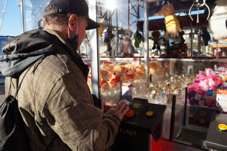Varna, Bulgaria - November, 27, 2020: men playing on the machine with soft toysのeditorial素材