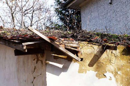 destroyed ceramic tiles on the roof of an old house.