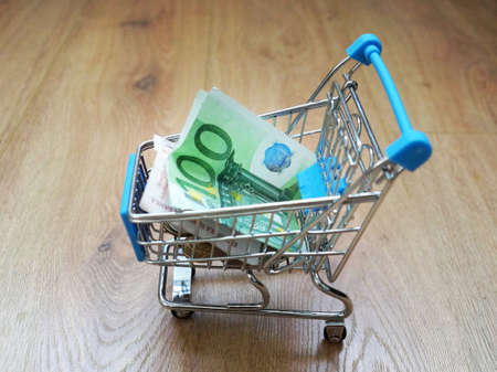cash paper money euro in a shopping cart as a saving and shopping concept.の写真素材