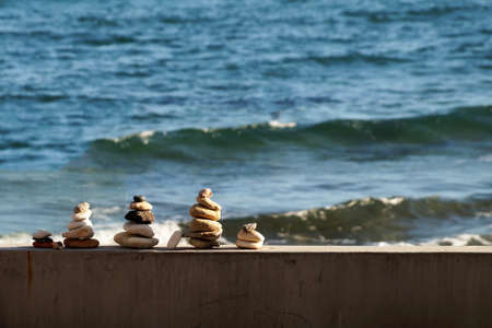 small Japanese stone pyramids on the background of the sea horizon