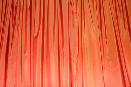 orange draped curtains close-up texture for textile backgroundの写真素材