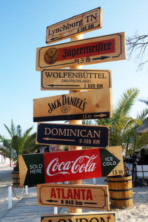 Varna, Bulgaria - August, 22, 2021: wooden decorative signage pointers on the pillar on the beach