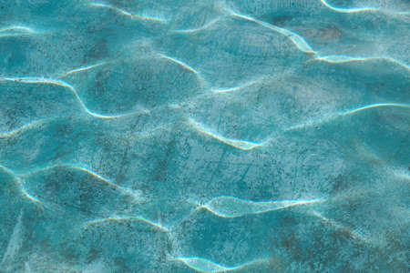 pool water surface with reflected sun glare for blue background.