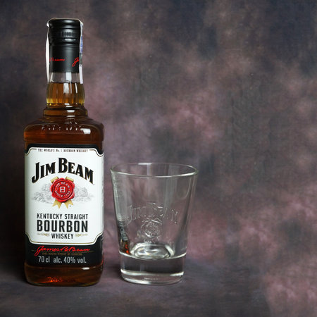 Varna, Bulgaria - December, 13, 2021: Jim Beam whiskey bottle and a glass for whiskey on dark vintage backgroundのeditorial素材