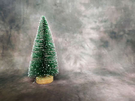 small christmas artificial tree on dark vintage background, copy space.の写真素材