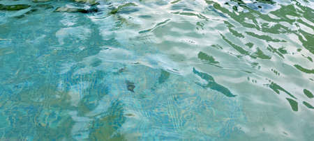 sun glare in clear pool water for blue water background.