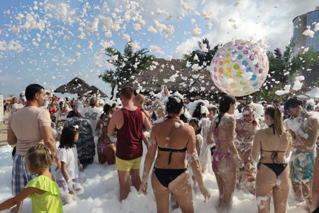 Golden Sands, Bulgaria - July 30, 2022: foam party on the beach, people throw up a big balloonのeditorial素材