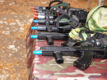 laser gaming automatic shotguns on a table in the woodsの写真素材