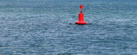 Close-up of a red buoy on the water for a horizontal background.の写真素材