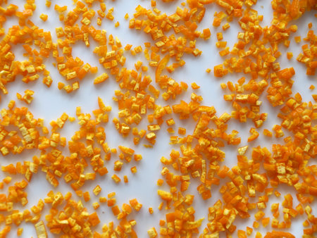 finely chopped orange peels on white table for food background.の写真素材