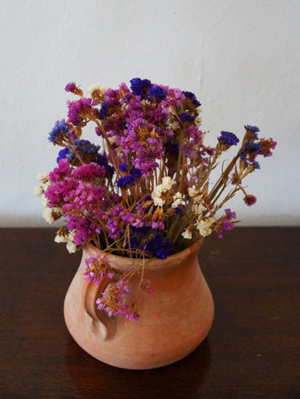Flower arrangement of dried flowers in a clay pot close-upの写真素材