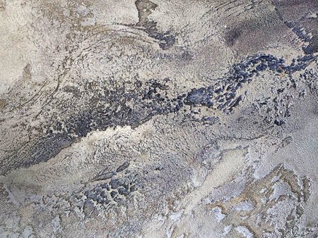 Gray texture of decorative plaster Travertine close-up.