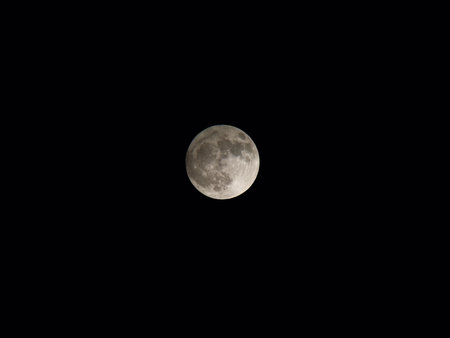 Full moon. Round full moon close-up on black sky, photo from telescope.