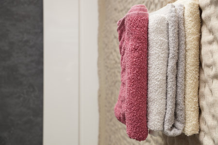 A close-up of a stack of terry towels on a bed.の写真素材