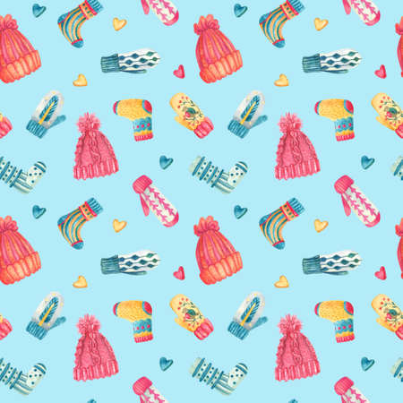 Watercolor seamless pattern with knitted warm clothes. Colorful cute hats, mittens, socks on light blue. Winter or Christmas textile. Great for kids or baby fabrics, Xmas wrapping papers, covers.の写真素材