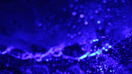 blue abstract space background with sparks of bright splashes, art bokeh with chaotic details of...