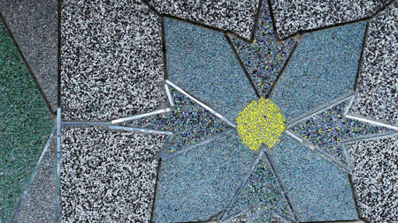 mosaic of small colored stones on the exterior wall of the house with the borders of the pattern in...