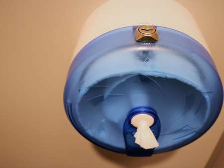 plastic round container with paper napkins for public toilets, tissue box made of clear colored plastic with a lock for wiping hands after washing, paper napkins in a container in public areasの写真素材