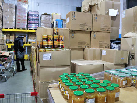 Maykop, Adygeya republic, Russia - March 15, 2022: grocery store warehouse with rows of boxes with cans of canned food, shopping malls of a grocery hypermarket in Russiaのeditorial素材
